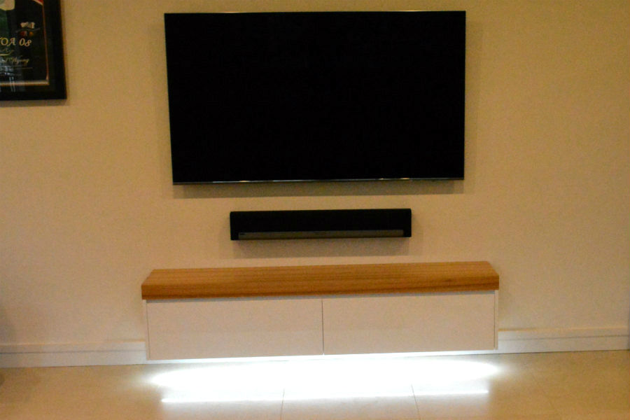 Custom made free floating entertainment unit with black butt top and led down lights. Custom made joinery and cabinet making.