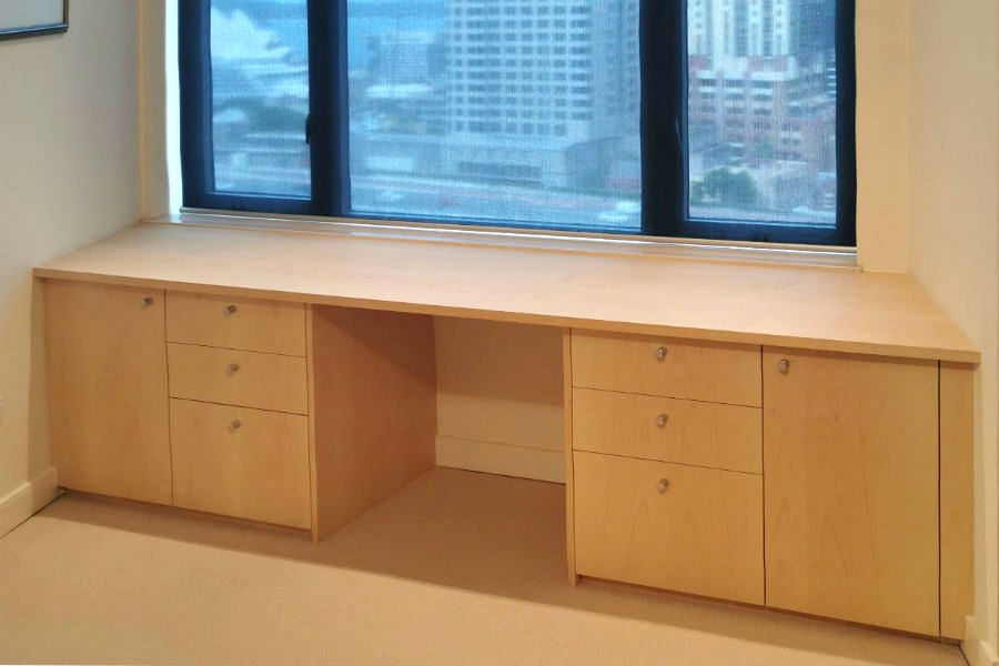 This custom made desk was part of a home office we made for a client in Kent St, Sydney CBD. Made from sycamore veneer with chrome handles to match other joinery that is in client's home. Built to fit with-in the angled walls in this apartment.