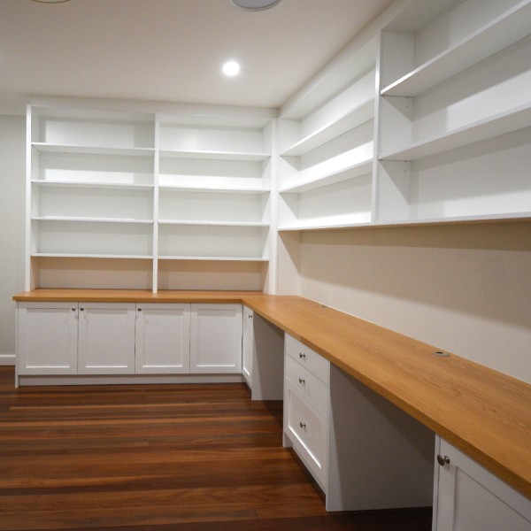 This two-seater home office with built-in bookcases was built for a customer in Pymble with shaker-style doors and timber oak benchtop. Finished in satin white ploy paint with clear satin on the bench top using Blum hinges and draw runner.