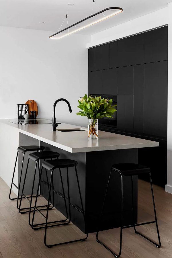 Designed with the customer brief for a minimalist style with a monochromatic colour pallet. We achieved this with the use of black cabinets, white walls, and the Quantum Quartz Concrete Matte benchtop The clean minimalist design with integrated appliances and no handed.