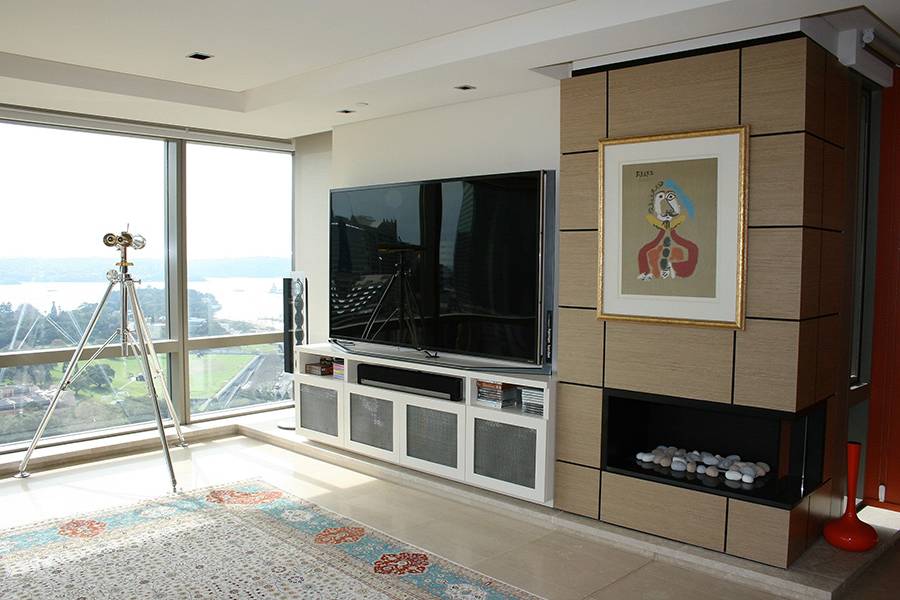 Custom-made Entertainment unit in Sydney CBD. Poly is painted in vivid white with shaker-style doors. Custom-made joinery and cabinet making.