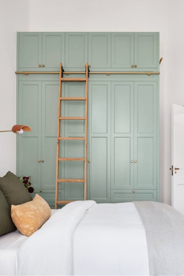 A custom-made wardrobe with a ladder made in a shaker style.